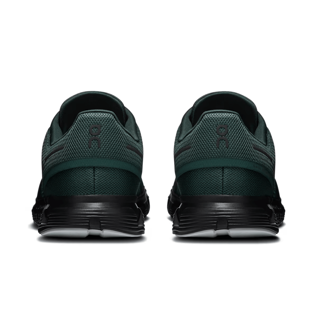 Green running shoes with a visible brand logo on a white background