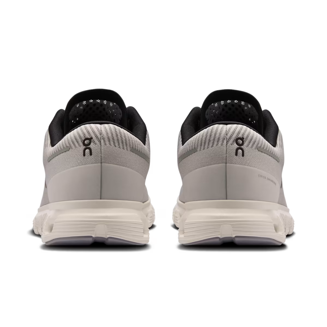 Pair of gray running shoes with black accents on a white background