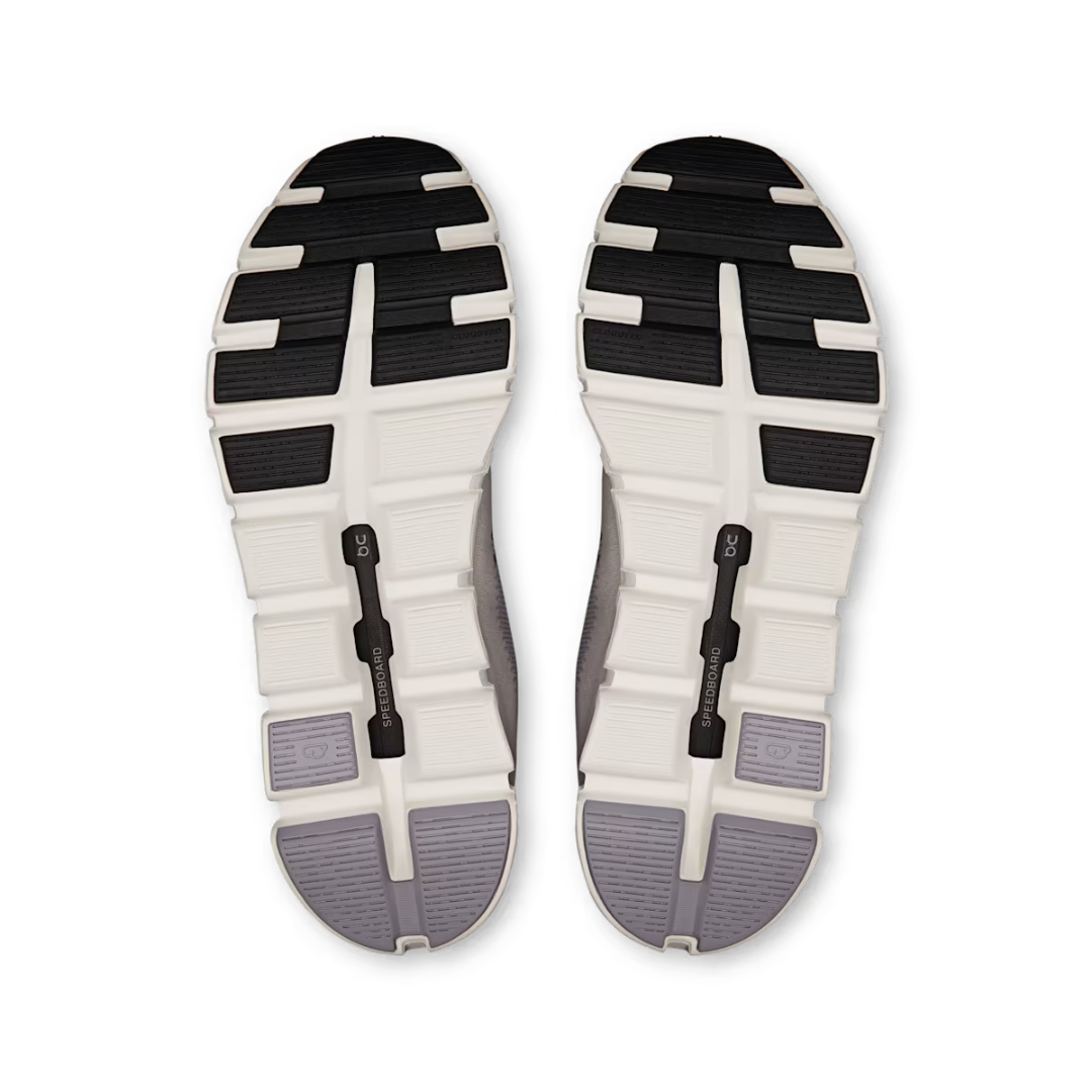 Top view of a pair of shoes with a white sole and black and gray accents on a white background