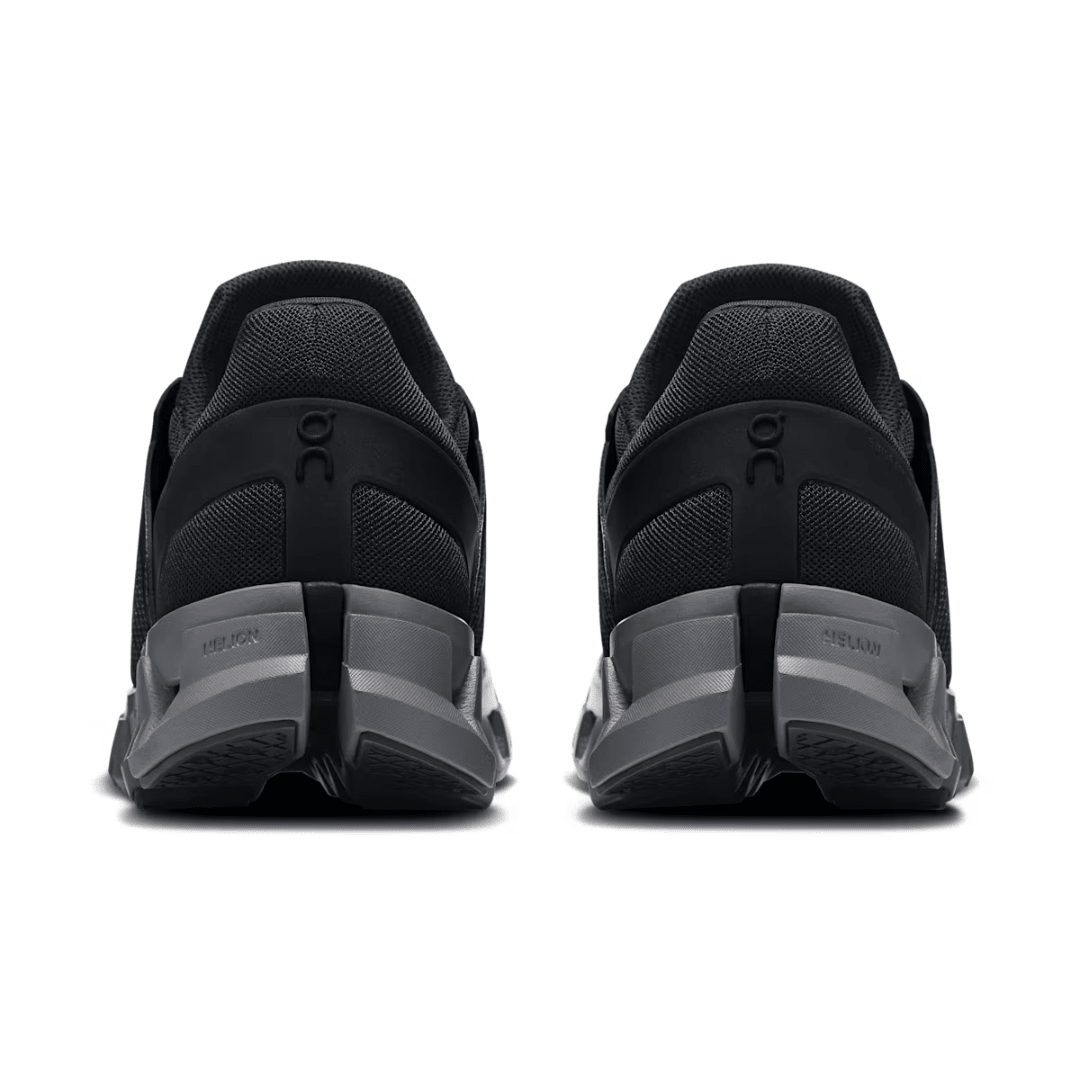 Black running shoes with gray soles on a white background